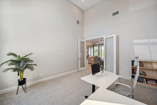 office area with visible vents, baseboards, light colored carpet, and an inviting chandelier