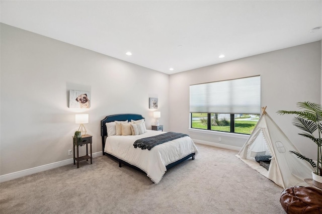 bedroom featuring recessed lighting, light colored carpet, and baseboards