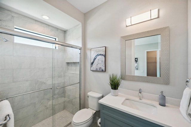 full bath featuring vanity, toilet, and a shower stall