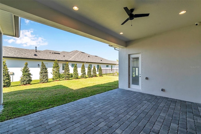 view of patio featuring a ceiling fan and fence