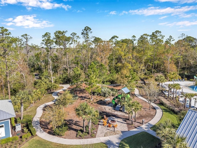 drone / aerial view with a wooded view