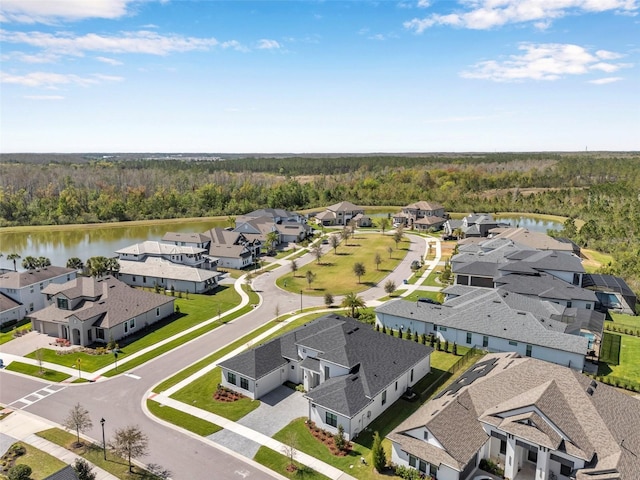 birds eye view of property with a forest view, a residential view, and a water view