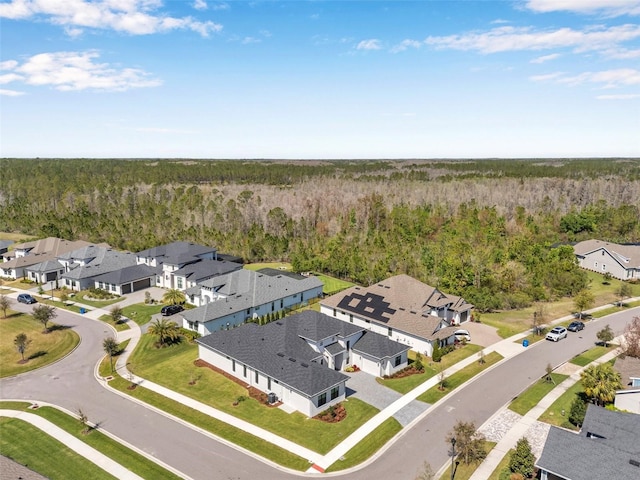 bird's eye view featuring a forest view and a residential view