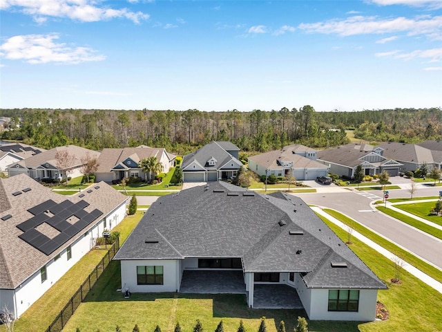 aerial view with a residential view and a view of trees