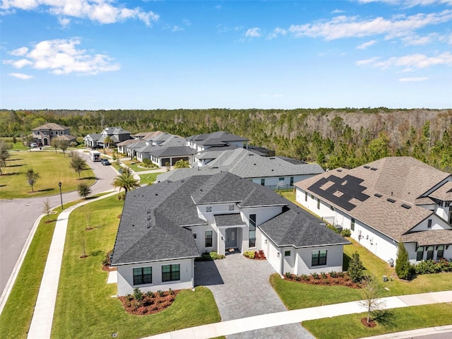 drone / aerial view with a residential view and a forest view