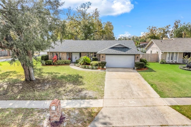 ranch-style house featuring fence, a shingled roof, a front lawn, concrete driveway, and a garage