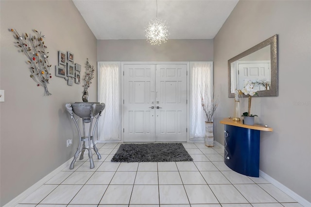 foyer entrance featuring light tile patterned floors, baseboards, and an inviting chandelier