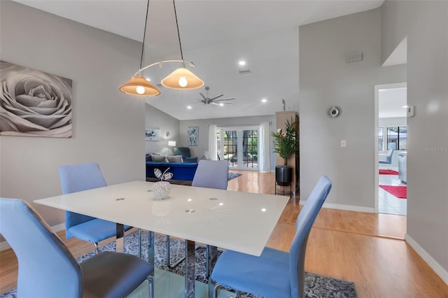 dining space with baseboards, light wood finished floors, lofted ceiling, recessed lighting, and ceiling fan