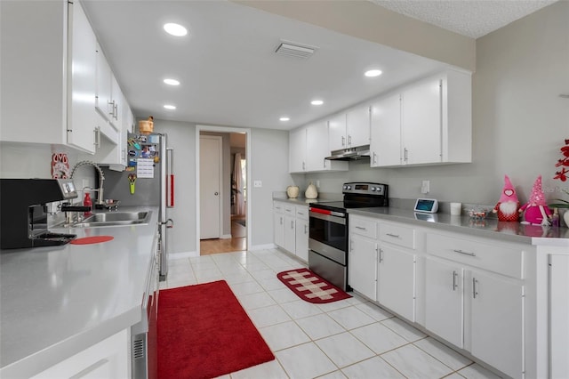 kitchen with visible vents, under cabinet range hood, stainless steel electric stove, recessed lighting, and light tile patterned flooring