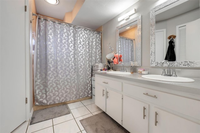 full bathroom with a sink, double vanity, and tile patterned floors