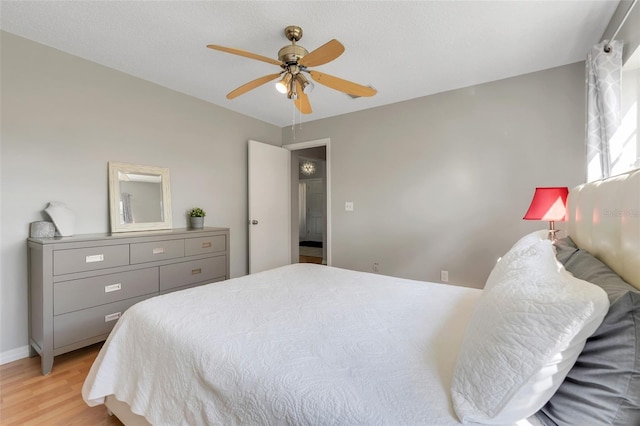 bedroom featuring light wood finished floors and ceiling fan