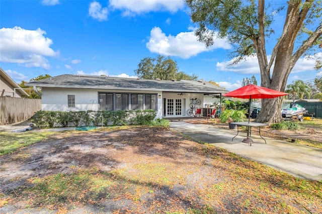 back of house featuring stucco siding, french doors, a patio, and fence