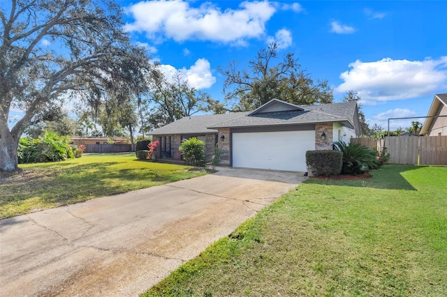 ranch-style house featuring fence, a shingled roof, concrete driveway, a front lawn, and a garage