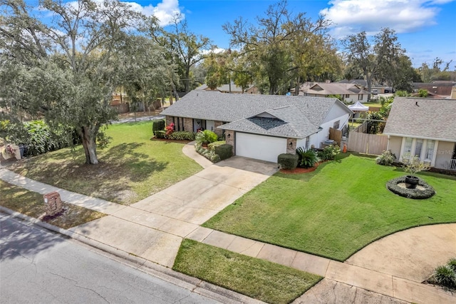 view of front of house with a garage, concrete driveway, a front lawn, and a shingled roof