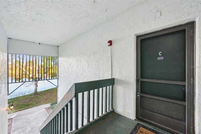 doorway to property featuring stucco siding