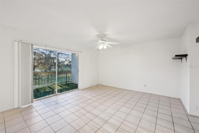 spare room featuring light tile patterned floors and a ceiling fan