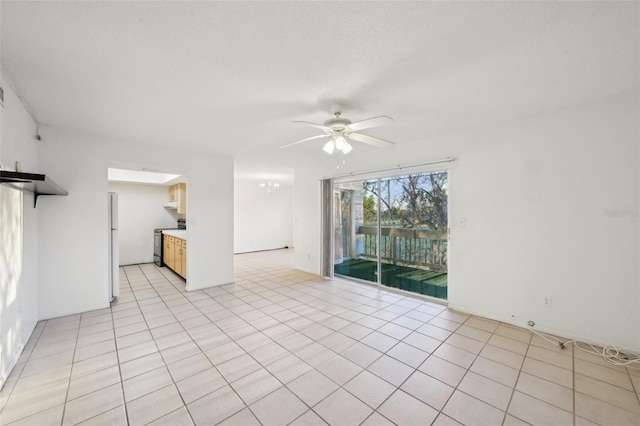 unfurnished living room featuring light tile patterned floors and ceiling fan with notable chandelier