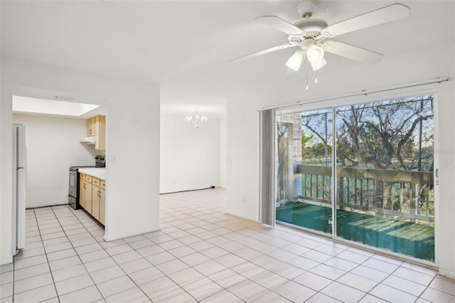 kitchen featuring ceiling fan with notable chandelier, electric stove, freestanding refrigerator, light countertops, and light tile patterned floors