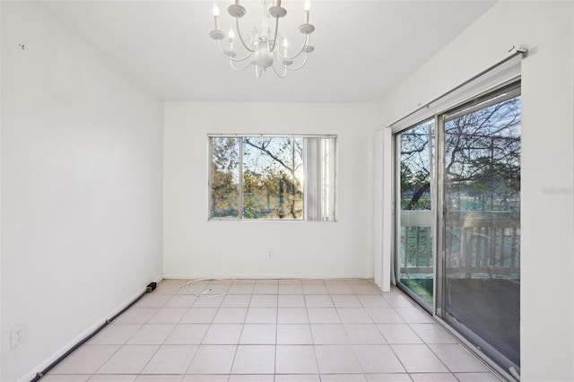 unfurnished room featuring baseboards, a notable chandelier, and light tile patterned flooring