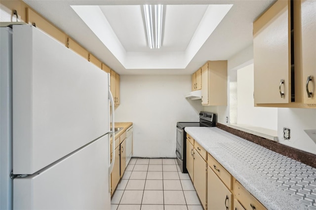 kitchen with white appliances, light tile patterned floors, a tray ceiling, light countertops, and under cabinet range hood