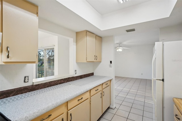 kitchen featuring visible vents, ceiling fan, light countertops, freestanding refrigerator, and light tile patterned flooring