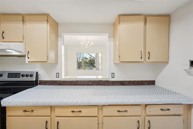 kitchen with under cabinet range hood, a chandelier, electric stove, and light stone counters