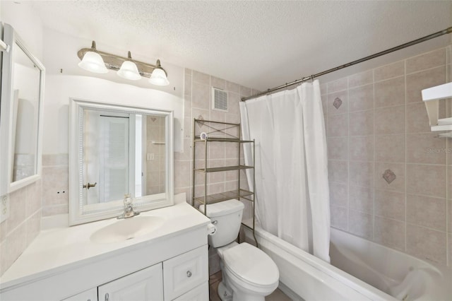 bathroom featuring visible vents, tile walls, vanity, shower / bath combination with curtain, and a textured ceiling