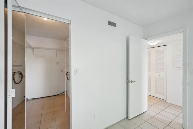 interior space with visible vents, a closet, and light tile patterned flooring