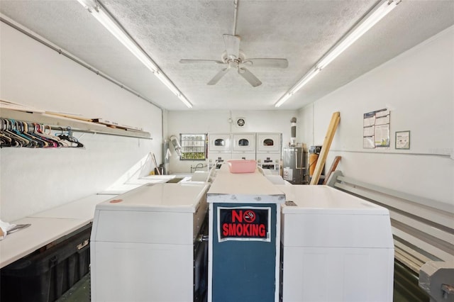 community laundry room featuring a ceiling fan, washing machine and dryer, and a textured ceiling