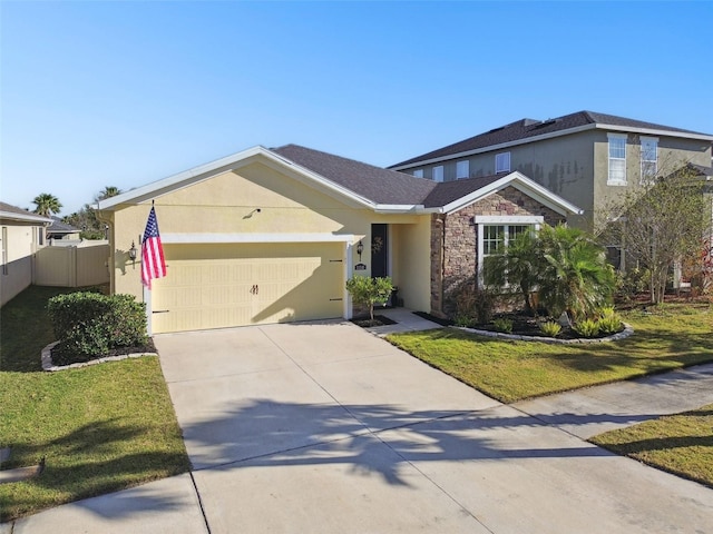 traditional-style home with a front yard, driveway, stucco siding, stone siding, and a garage