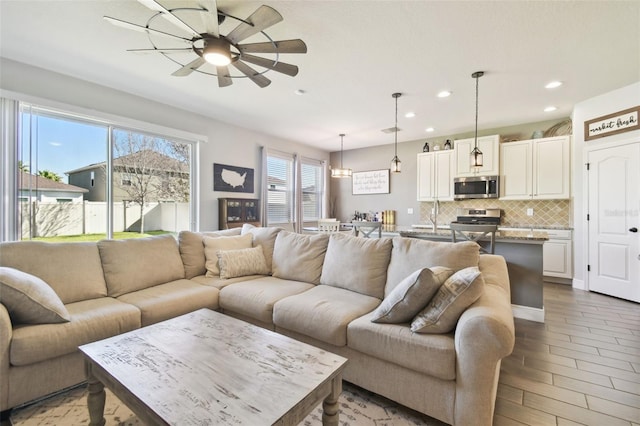 living room with wood finished floors, recessed lighting, and a ceiling fan