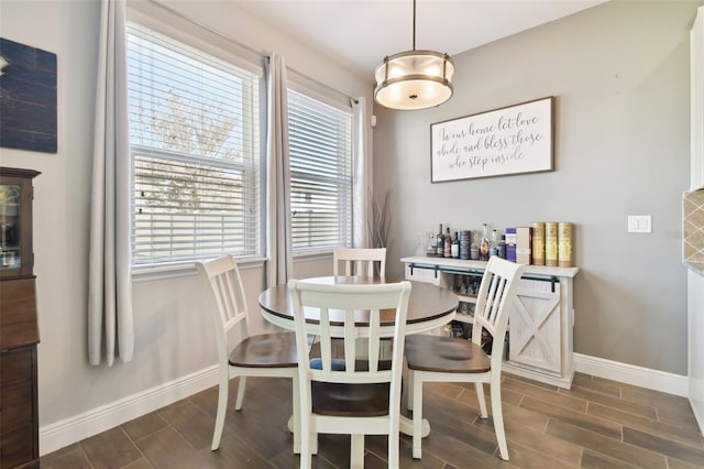 dining area featuring wood finish floors and baseboards