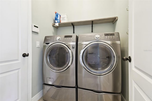 washroom featuring washing machine and dryer and laundry area