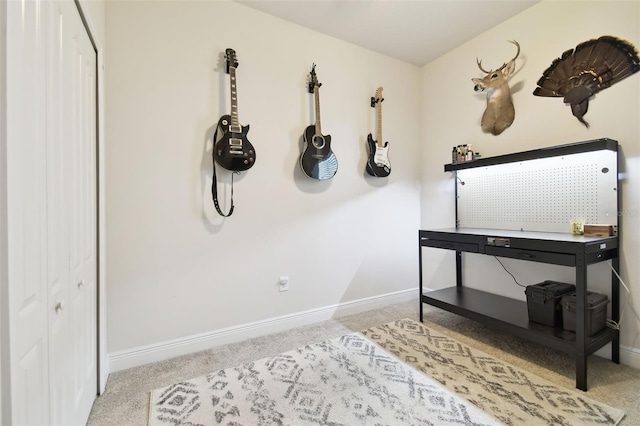 misc room with baseboards and carpet floors