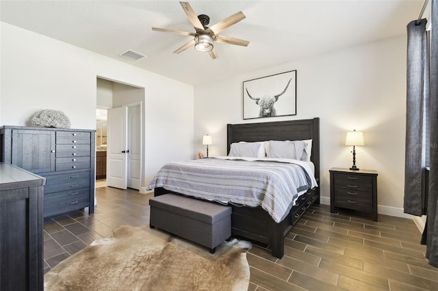 bedroom with baseboards, visible vents, wood finish floors, ensuite bath, and ceiling fan