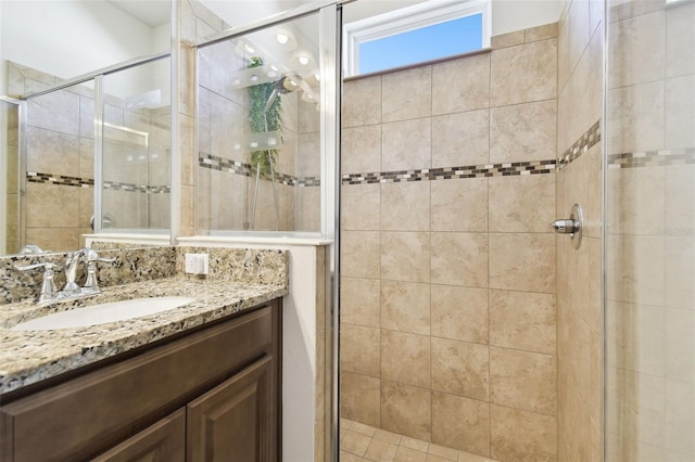 bathroom featuring a shower stall and vanity