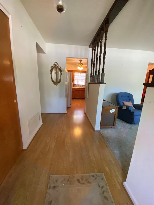 hall with wood finished floors