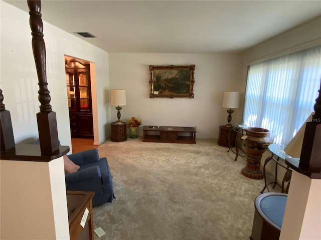 carpeted living room featuring visible vents