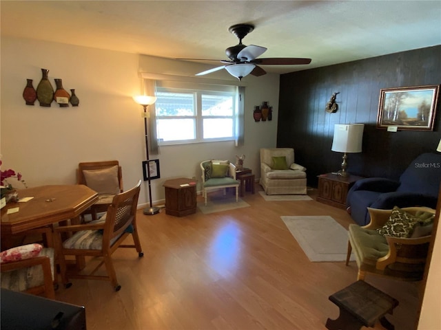 living area with ceiling fan and light wood-style floors