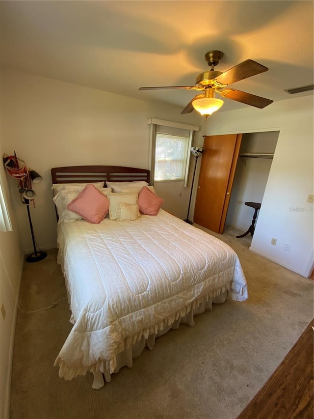 bedroom featuring a closet, visible vents, ceiling fan, and carpet flooring