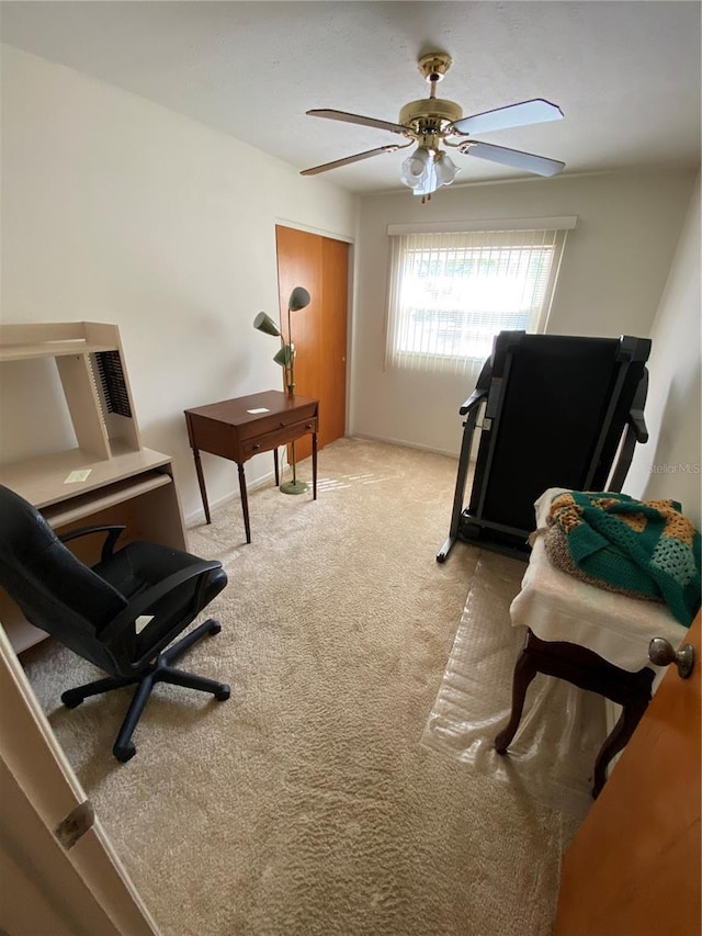 carpeted office with ceiling fan