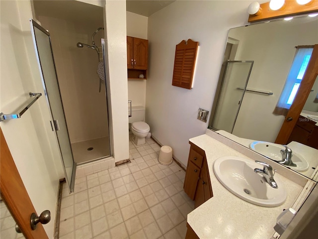 bathroom featuring baseboards, toilet, a stall shower, and vanity