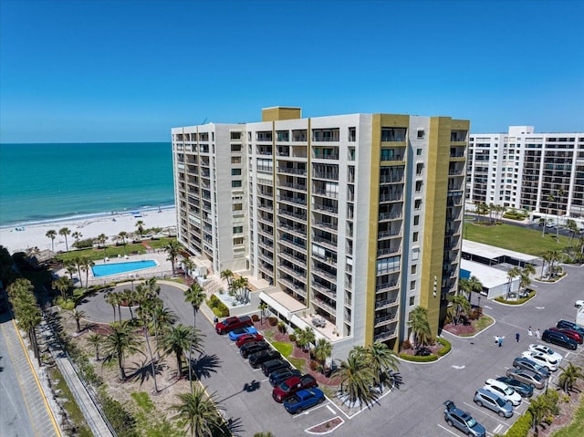 view of property with a view of the beach and a water view