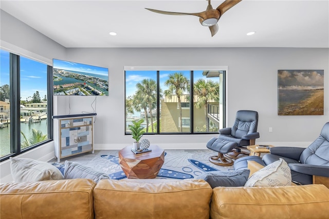 living area with recessed lighting, baseboards, and ceiling fan