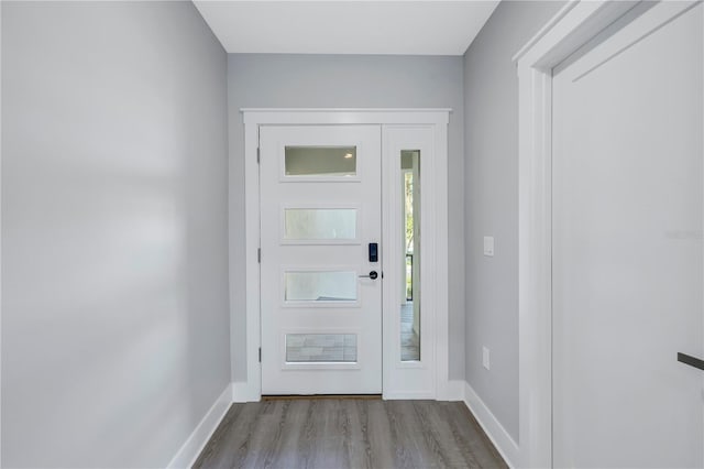 entryway featuring baseboards and wood finished floors