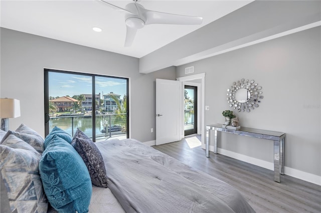 bedroom featuring visible vents, wood finished floors, baseboards, and access to exterior