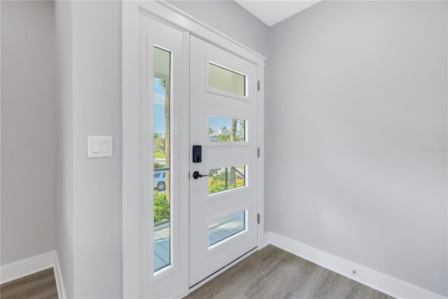 foyer entrance with wood finished floors and baseboards