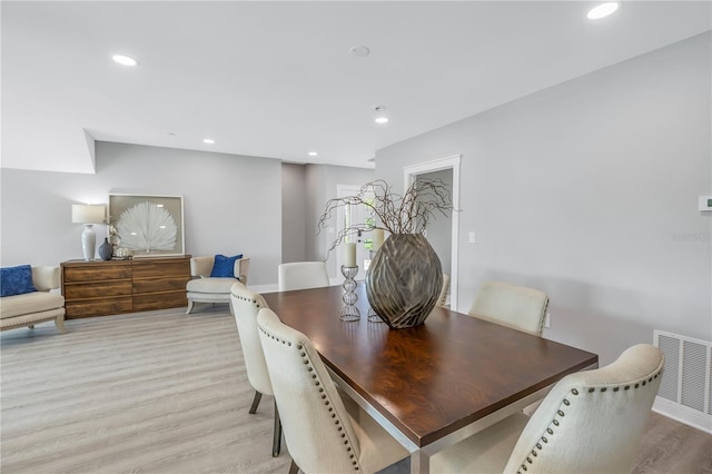 dining room featuring light wood-type flooring, visible vents, baseboards, and recessed lighting