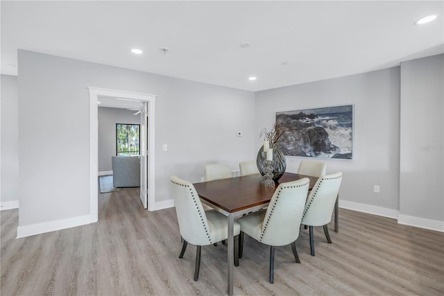 dining room with recessed lighting, light wood-style floors, and baseboards