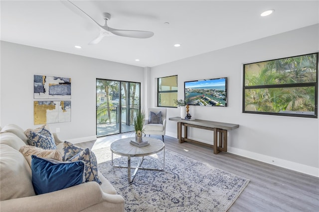 living area featuring recessed lighting, baseboards, wood finished floors, and ceiling fan